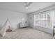 This is a spacious and well-lit bedroom with neutral carpet and large window at 120 Wellspring Dr, Holly Springs, NC 27540