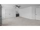 Bedroom featuring light colored carpet, ceiling fan, and ensuite wet bar at 120 Wellspring Dr, Holly Springs, NC 27540