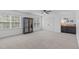 Bright bedroom with two windows, neutral carpet, and a ceiling fan at 120 Wellspring Dr, Holly Springs, NC 27540