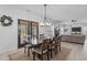 Bright dining room with backyard views, a wooden table, and natural lighting with a fireplace in view at 120 Wellspring Dr, Holly Springs, NC 27540