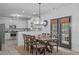 Open dining area with a wooden table, chairs, and natural light from a backyard-facing door at 120 Wellspring Dr, Holly Springs, NC 27540
