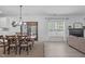 Open concept dining area with wood table, seating for six, and easy access to the living room at 120 Wellspring Dr, Holly Springs, NC 27540