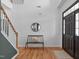 Welcoming foyer with hardwood floors, a staircase, front door with sidelights, and a decorative mirror and bench at 120 Wellspring Dr, Holly Springs, NC 27540