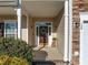 Inviting entryway with a decorated brown door, sidelights, and stone accents around the two-car garage at 120 Wellspring Dr, Holly Springs, NC 27540