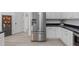 Modern kitchen featuring stainless steel appliances, white cabinetry, and sleek black countertops at 120 Wellspring Dr, Holly Springs, NC 27540
