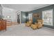 Inviting living room with plush armchairs, carpet, and large windows at 120 Wellspring Dr, Holly Springs, NC 27540