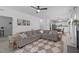 Spacious living room with an L-shaped sofa, decor, and views of the kitchen and dining area at 120 Wellspring Dr, Holly Springs, NC 27540