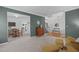 Open-concept living room featuring hardwood floors, carpet, and natural light at 120 Wellspring Dr, Holly Springs, NC 27540