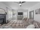 Cozy living room with a fireplace, comfortable sofa, ceiling fan, and natural light at 120 Wellspring Dr, Holly Springs, NC 27540