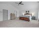 Bright, spacious bedroom with ceiling fan, neutral colors, and comfortable furnishings at 120 Wellspring Dr, Holly Springs, NC 27540