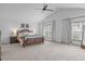 Large bedroom with natural light, king bed, ceiling fan, and neutral color palette at 120 Wellspring Dr, Holly Springs, NC 27540