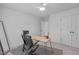 Clean home office with modern desk, comfortable chair, and ample natural light at 120 Wellspring Dr, Holly Springs, NC 27540