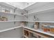 Well-organized pantry with white shelves, wire baskets, and visible food storage containers at 120 Wellspring Dr, Holly Springs, NC 27540