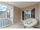 Cozy covered porch with an egg chair and natural light at 120 Wellspring Dr, Holly Springs, NC 27540