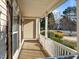 Inviting front porch with white railing and trim, offering a cozy spot to relax and enjoy the neighborhood view at 120 Wellspring Dr, Holly Springs, NC 27540