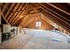 Unfinished attic space with exposed rafters, plywood flooring and natural light ready to be customized at 1204 Croydon Glen Ct, Cary, NC 27519