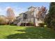 View of the back of this gray two story home with a spacious green lawn at 1204 Croydon Glen Ct, Cary, NC 27519