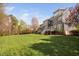 View of back of home showing a large yard and deck on a sunny day at 1204 Croydon Glen Ct, Cary, NC 27519