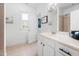 White bathroom featuring a window, door, and drawers at 1204 Croydon Glen Ct, Cary, NC 27519