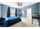 Blue bedroom featuring a ceiling fan, shelves, and natural light at 1204 Croydon Glen Ct, Cary, NC 27519