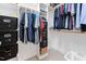 Well-organized walk-in closet with rods, shelves, and storage bins for clothes at 1204 Croydon Glen Ct, Cary, NC 27519