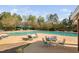 View of community pool with lounge chairs and umbrellas, perfect for summer relaxation at 1204 Croydon Glen Ct, Cary, NC 27519