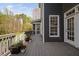 Inviting outdoor deck with gray wood, white railings, and potted plants offering a relaxing view at 1204 Croydon Glen Ct, Cary, NC 27519