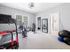 Well-equipped home gym with windows, mirrors and an open floor plan perfect for exercising at 1204 Croydon Glen Ct, Cary, NC 27519