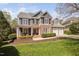 Charming two-story home featuring a stone and siding facade, well-manicured lawn and a two car garage at 1204 Croydon Glen Ct, Cary, NC 27519