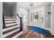 Inviting foyer with hardwood floors, a staircase, and a view into the bright and airy living spaces at 1204 Croydon Glen Ct, Cary, NC 27519