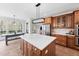Bright kitchen with a large island and stainless steel refrigerator at 1204 Croydon Glen Ct, Cary, NC 27519