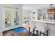 Bright kitchen featuring bar seating, large windows, and access to the outdoor deck at 1204 Croydon Glen Ct, Cary, NC 27519