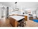 Open kitchen with a large island, stainless steel appliances, and view of the living room at 1204 Croydon Glen Ct, Cary, NC 27519