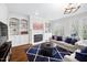 Cozy living room featuring a fireplace, built-in shelves, and large windows at 1204 Croydon Glen Ct, Cary, NC 27519