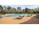 Community pool featuring lounge chairs, tables, and cabanas with lush green trees in the background at 1204 Croydon Glen Ct, Cary, NC 27519
