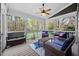 Relaxing screened porch with comfortable seating, a ceiling fan, and picturesque views of the surrounding landscape at 1204 Croydon Glen Ct, Cary, NC 27519