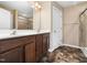 Bathroom with a double sink vanity and a shower featuring tiled walls at 1220 Falcon Ridge Ln, Morrisville, NC 27560