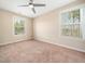 Bright bedroom featuring neutral walls, carpet, ceiling fan and large windows at 1220 Falcon Ridge Ln, Morrisville, NC 27560