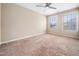 Bedroom features neutral walls, carpeting, two windows and a ceiling fan at 1220 Falcon Ridge Ln, Morrisville, NC 27560
