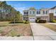Inviting two-story home with a lush front yard and a double-car garage at 1220 Falcon Ridge Ln, Morrisville, NC 27560