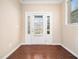 Inviting foyer featuring hardwood floors and a charming front door with sidelights at 1220 Falcon Ridge Ln, Morrisville, NC 27560