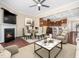 Open-concept living room with a fireplace and an adjacent dining area and kitchen at 1220 Falcon Ridge Ln, Morrisville, NC 27560
