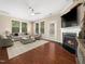 Cozy living room featuring a fireplace, plush seating and large windows with natural light at 1220 Falcon Ridge Ln, Morrisville, NC 27560