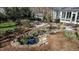 Secluded backyard featuring a rock-lined pond, stone patio, and lush landscaping at 1229 Westerham Dr, Wake Forest, NC 27587