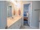 Bright bathroom with a white vanity, sink, and a doorway that opens into the bedroom at 1229 Westerham Dr, Wake Forest, NC 27587