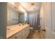 Bathroom featuring double vanity with granite countertop, large mirror, and tiled floors at 1229 Westerham Dr, Wake Forest, NC 27587