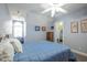 A well-lit bedroom featuring a window, paintings, and light blue walls for a cozy feel at 1229 Westerham Dr, Wake Forest, NC 27587