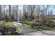 Inviting home with a long driveway framed by manicured lawns and mature trees at 1229 Westerham Dr, Wake Forest, NC 27587