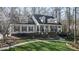 Charming home featuring a manicured lawn, complemented by a two-story facade and a welcoming front porch at 1229 Westerham Dr, Wake Forest, NC 27587
