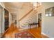 Elegant foyer with hardwood floors, a staircase, and a glimpse into adjacent living areas at 1229 Westerham Dr, Wake Forest, NC 27587